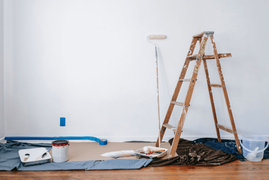 brown wooden ladder beside painting materials