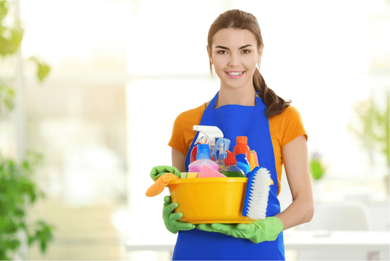 woman holding cleaning products