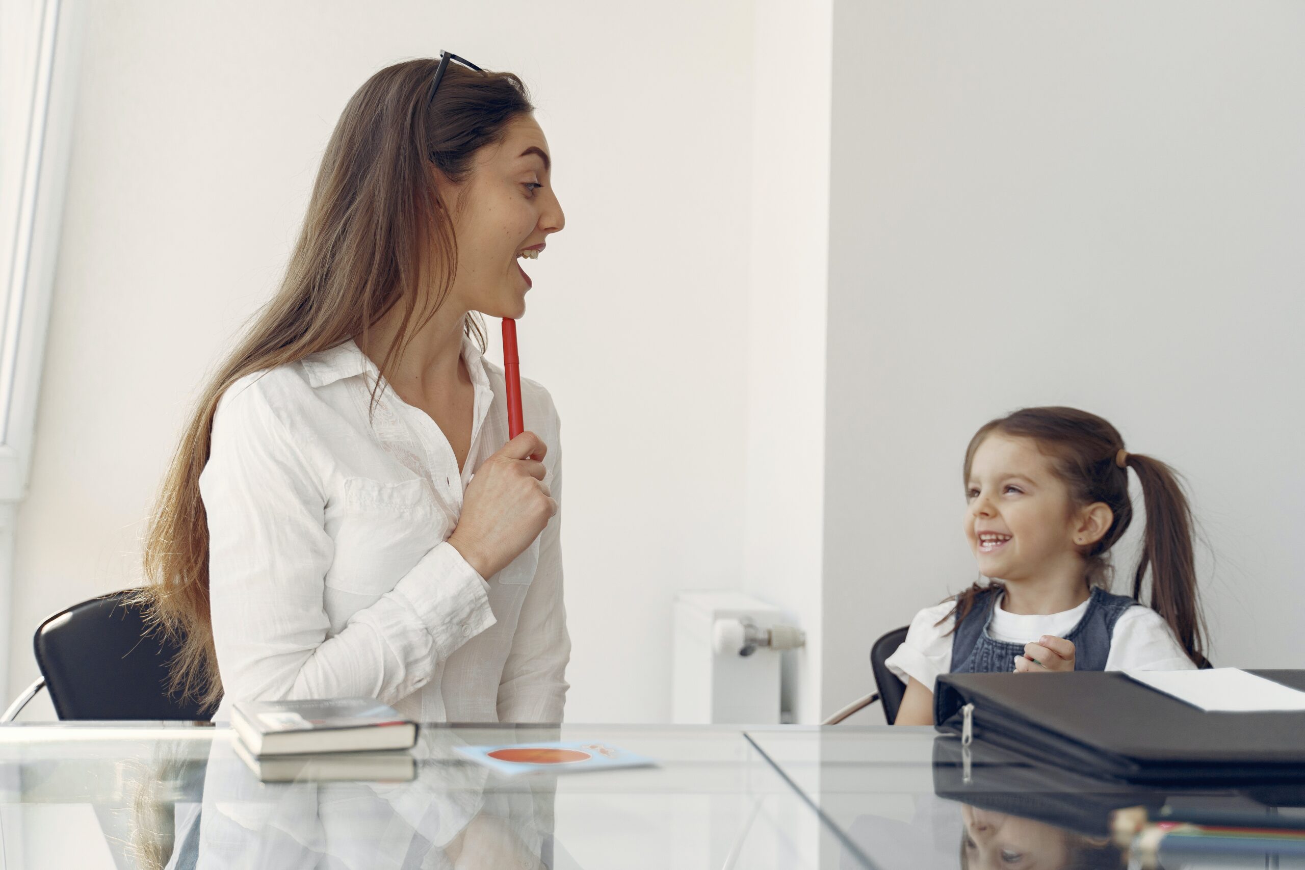 cheerful woman and kid having fun in office 4149077 scaled