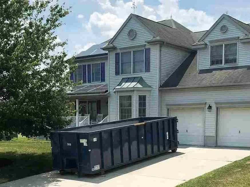 dumpster in grey house driveway rectangle Z1voHrF